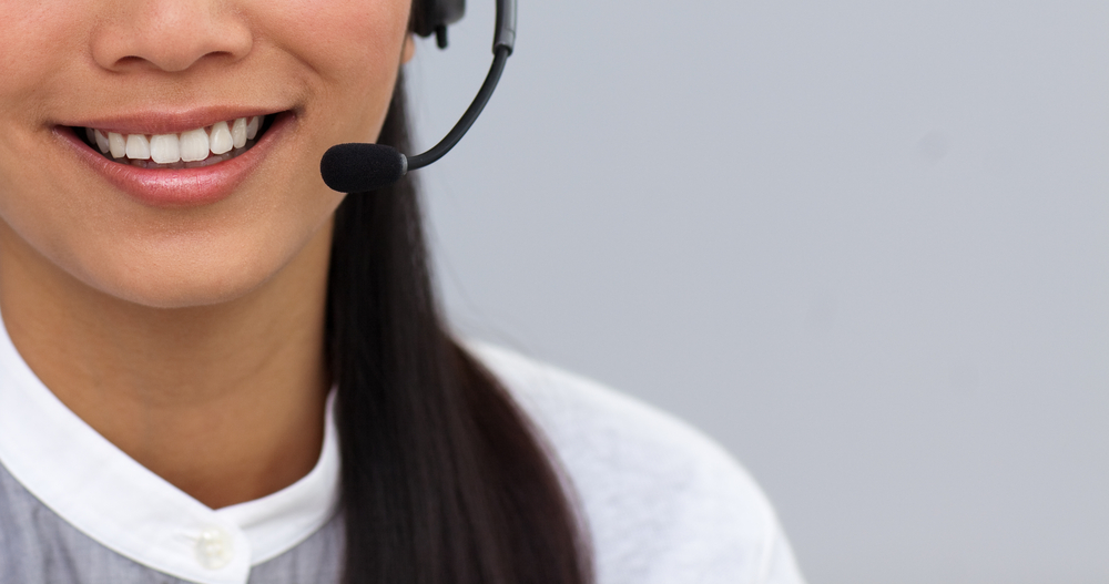 Close-up of a businesswoman using headset at work