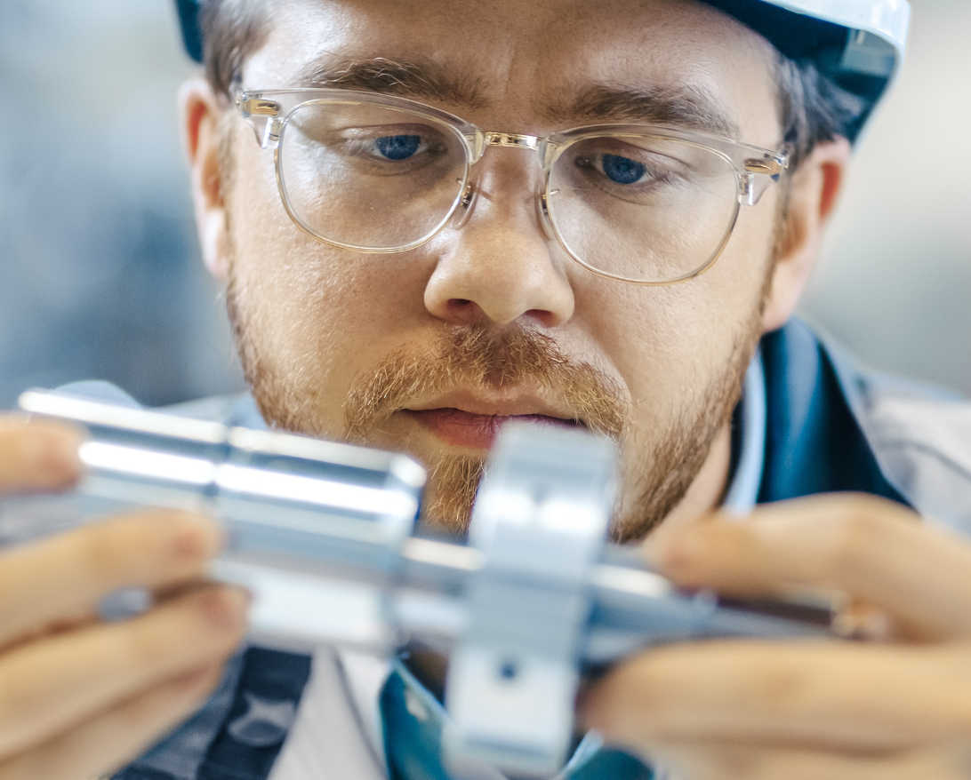 world quality day minitab; man in manufacturing looking closely at a widget